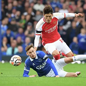 Clash at Goodison Park: Arsenal's Tomiyasu Faces Off Against Everton's Garner (2023-24)