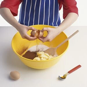 Adding ingredients for a chocolate sponge cake in a mixing bowl