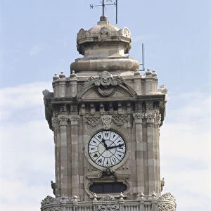 Asia, Turkey, Istanbul, detail of the Dolmabahce Clocktower, hands on face pointing to 11: 13, square grey stone tower with weather vane on roof