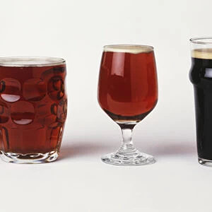 Assorted beers in their special glasses, front view
