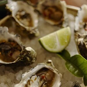 Australia, Oyster with lime slice on crushed ice