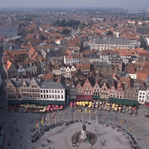 Belgium, Bruges, view from the Belfort, of medieval houses and streets around a market square lined with cafes and restaurants