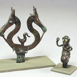 Bronze figures of a kneeling woman and two animal heads