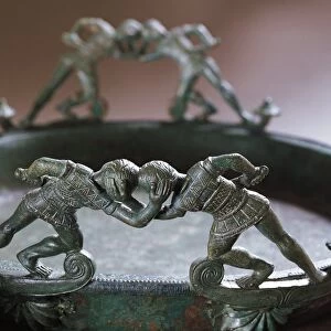 Bronze vessel with handles in shape of two pairs of fighting warriors from the necropolis of Filottrano, Marche Region, Italy, detail