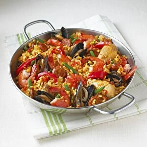 Chicken and seafood paella in pan