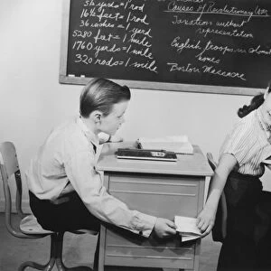 Children exchanging notes during class, 1950s-60s