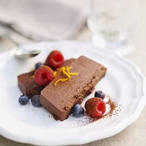 Chocolate parfait with orange zest, raspberries and blueberries, close-up