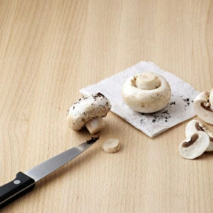 Cleaning mushrooms with knife, close-up