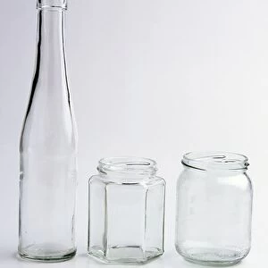 Clear glass bottle and two clear glass jars