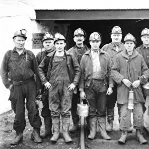 Coal miners at the entrance of a mine