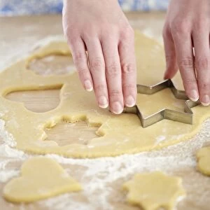 Cookie cutter cutting pastry shapes, close-up