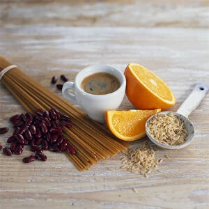 Cup of coffee, orange slices, brown rice, wholemeal (wholewheat) spaghetti and red kidney beans