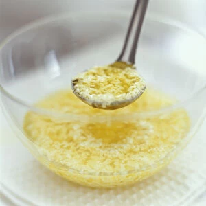 Curdled mayonnaise in glass mixing bowl and on ladle
