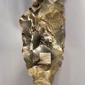 Double-bladed flint ax with label of original inventory by Jacques Boucher de Perthes, from Saint-Acheul diluvium
