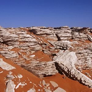 Egypt, Western Desert, Libyan Desert, Gilf Kebir Plateau, Wadi Abd el-Malik Valley, Rock formations standing out from brown-colored soil