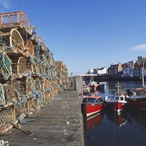 England, North Yorkshire, lobster pots lining the quayside of Whitby harbour