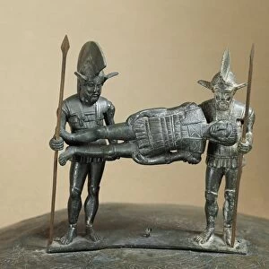 Etruscan civilization, Kist handle in bronze, portraying two warriors carrying wounded comrade, From Preneste, Palestrine Hill (Rome)