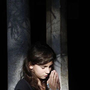 Girl praying in Saint-Trophime cloister