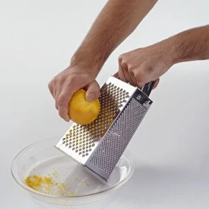 Grating lemon to remove zest