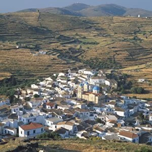 Greece, Kythos, red-roofed village of Dryopida, blue domed church clearly distinguishable, terraced fields surrounding