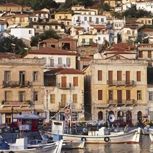 Greece, Mani Peninsula, boats moored in harbour below buildings on hillside