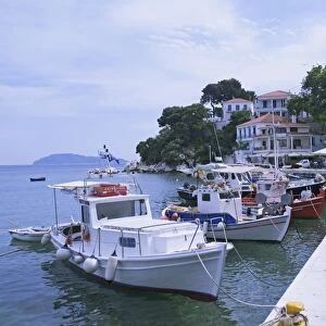 Greece, Sporades, Skiathos island, Skiathos town and harbour with boats moored on promenade