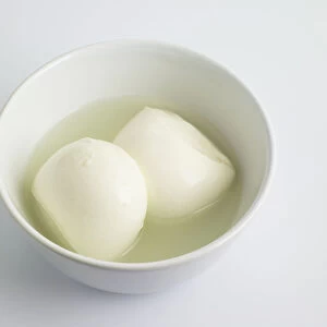 Italian Mozzarella cheese balls in bowl, close-up