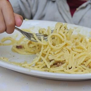 Italy, Lazio, Rome, child eating spaghetti carbonara