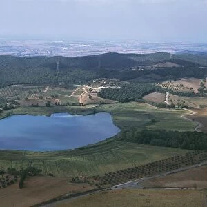 Italy, Tuscany, Grosseto, Lake Lago dell Accesa and surrounding Metalliferous Hills with Follonica in background