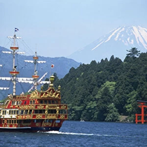 Japan, Central Honshu, motorised sailing ship on Lake Ashi with snow-capped Mount Fuji in background