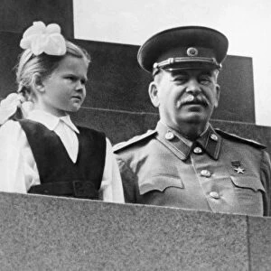 Joseph stalin at a may day celebration with first grade student vera kondakova, may 1, 1952, she stepped out of a column of pioneers and presented the premier with a bouquet of flowers