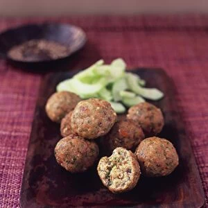 Kofte Samak, Moroccan spicy harissa fish cakes served with cucumber salad, on serving dish