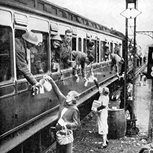Local residents supplying refreshments to trainload of British soldiers who had been