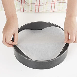 Making cheesecake, lining cake tin with wax paper