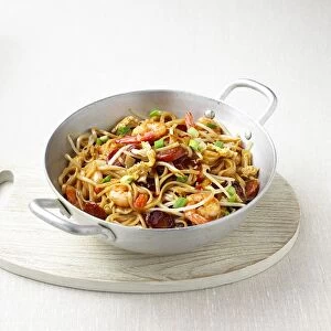 Malaysian noodles with shrimps and beansprouts in a wok