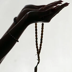 Muslim woman holding islamic prayer beads
