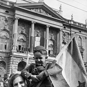 People on the streets of belgrade, yugoslavia during a celebration of the first anniversary of liberation from the germans