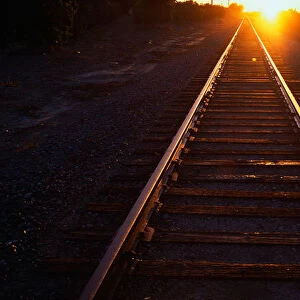 These are railroad tracks that go off into infinity at sunrise. The sun is at the end of the tracks at the horizon