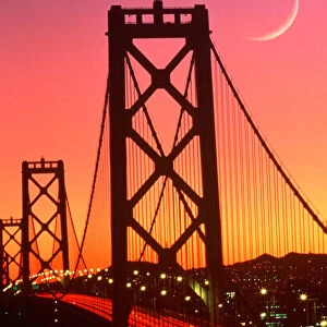 San Francisco Bay Bridge from Treasure Island with crescent moon at sunset