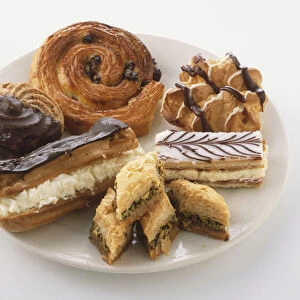 Selection of cakes and pastries on plate, close up