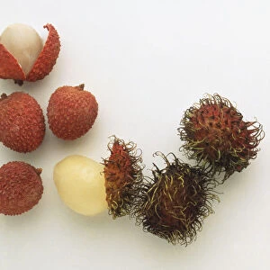 Selection of exotic fruit including Litchi chinensis, Lychees, Nephelium lappaceum, Rambutans, Passiflora sp. Passion Fruit, Passiflora ligularis, Granadillas, close up
