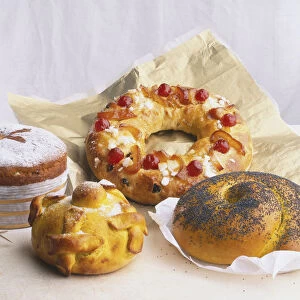 A selection of festive breads including Panettone; Pan de Muerto; Bolo-Rei; and Challah