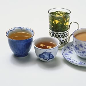 Servings of herbal, green and black teas in variety of cups and glasses