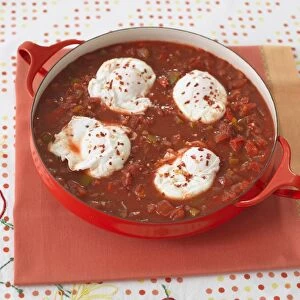 Shakshouka, eggs poached in tomato and pepper sauce, in a pan