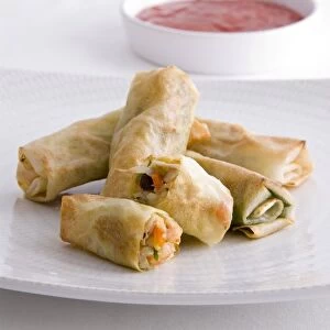 Shrimp spring rolls served with chilli dipping sauce, close-up