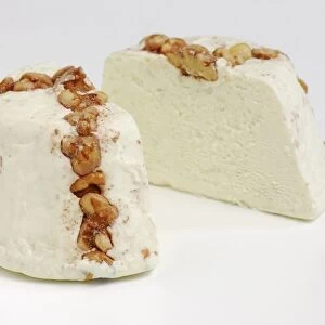 Sliced cone of Israeli Turkeez goats cheese with walnuts