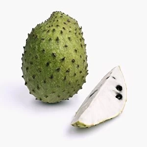 Whole and sliced guanabana (soursop) on white background, close-up