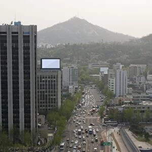South Korea, Seoul, view of inner-city road and Inwangsan mountain in the distance