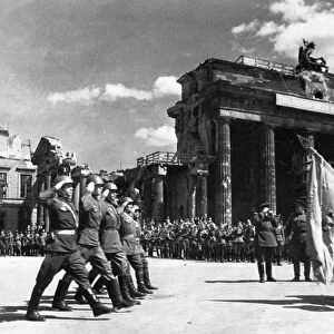 Soviet red army troops during a victory parade in front of the brandenburg gate in berlin, germany at the end of world war 2, may 20, 1945