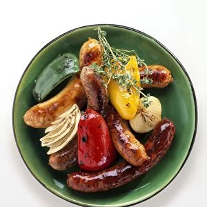 Toulouse and pork sausages served on green with peppers and onions